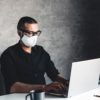 A man works or study during quarantine at the computer. Pandemic epidemic
