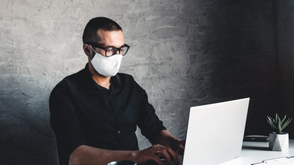 A man works or study during quarantine at the computer. Pandemic epidemic