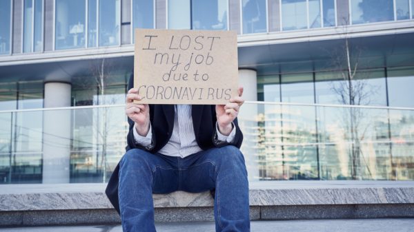 Job loss due to COVID-19 virus pandemic concept. Unrecognizable man holds sign "I lost my job"