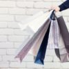 Man with bunch of shopping bags. Copy space. Sale, discount, black friday concept. Shopping mall and
