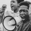 Young boy shouting on a megaphone in a protest