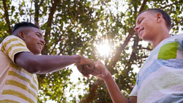 African And Caucasian Boys Joining Hands Against Racism