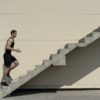 Concept of success and achieving your goal, man climbing stairs.