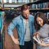 Students choosing a book in a library