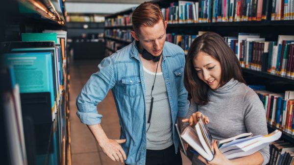 Students choosing a book in a library