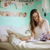 teen reading on her bed