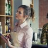 Waitress ordering products by digital tablet