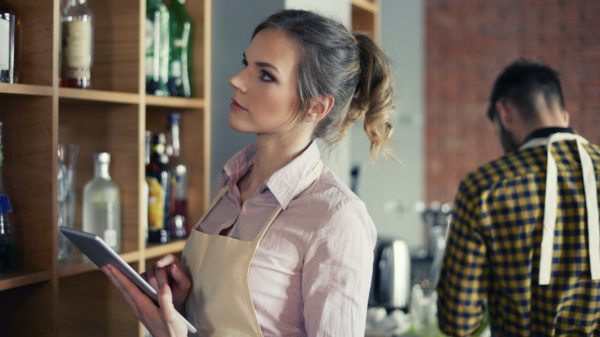 Waitress ordering products by digital tablet