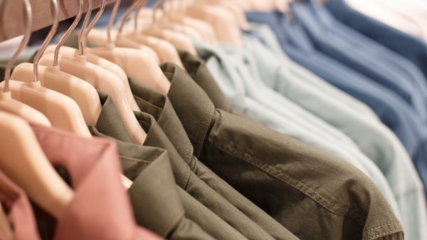 Row of hangers with shirts in a store